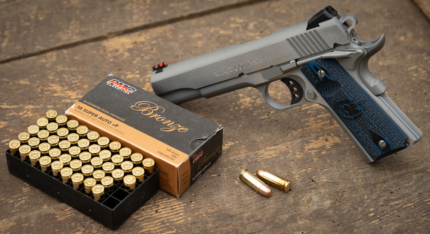 38 Super pistol and ammo on a table