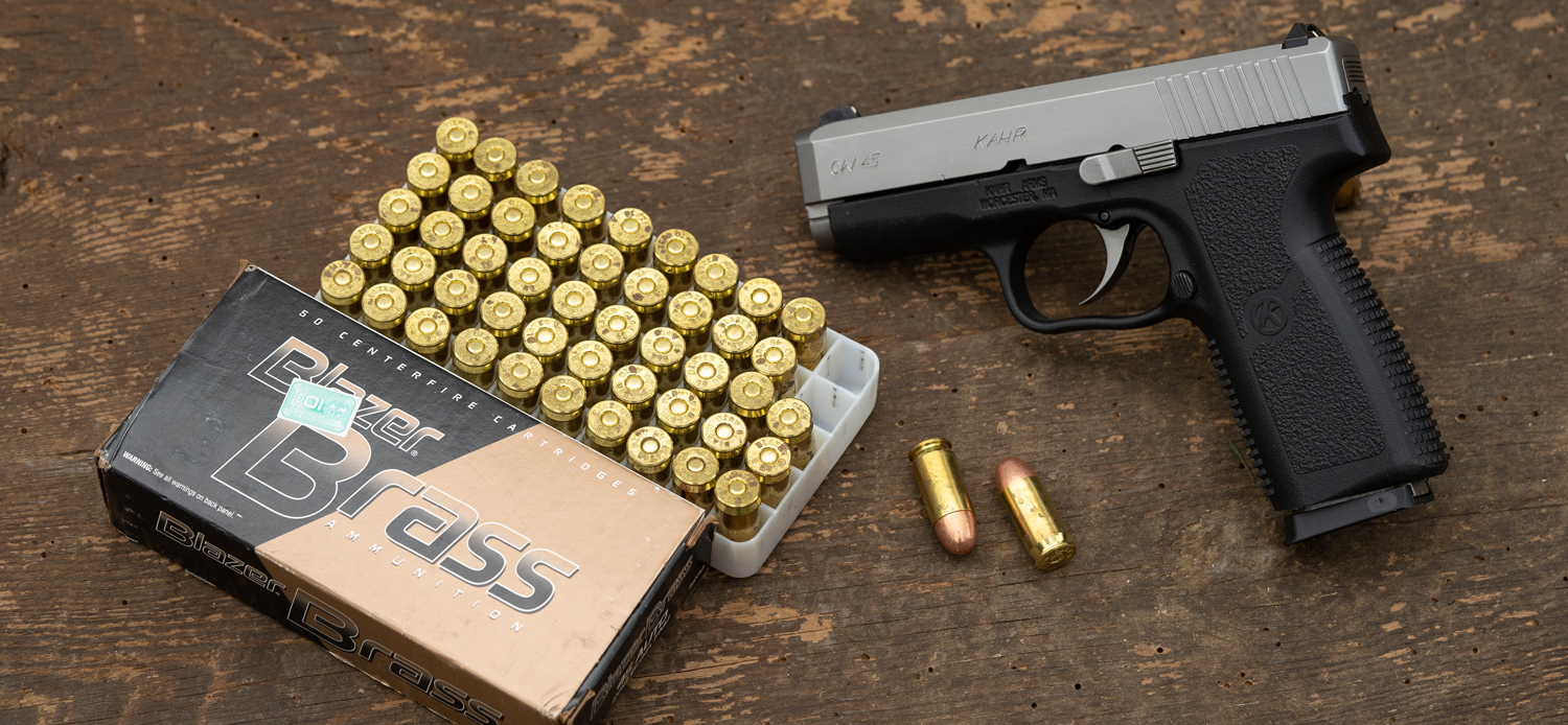 A 45 acp pistol and ammunition on a table