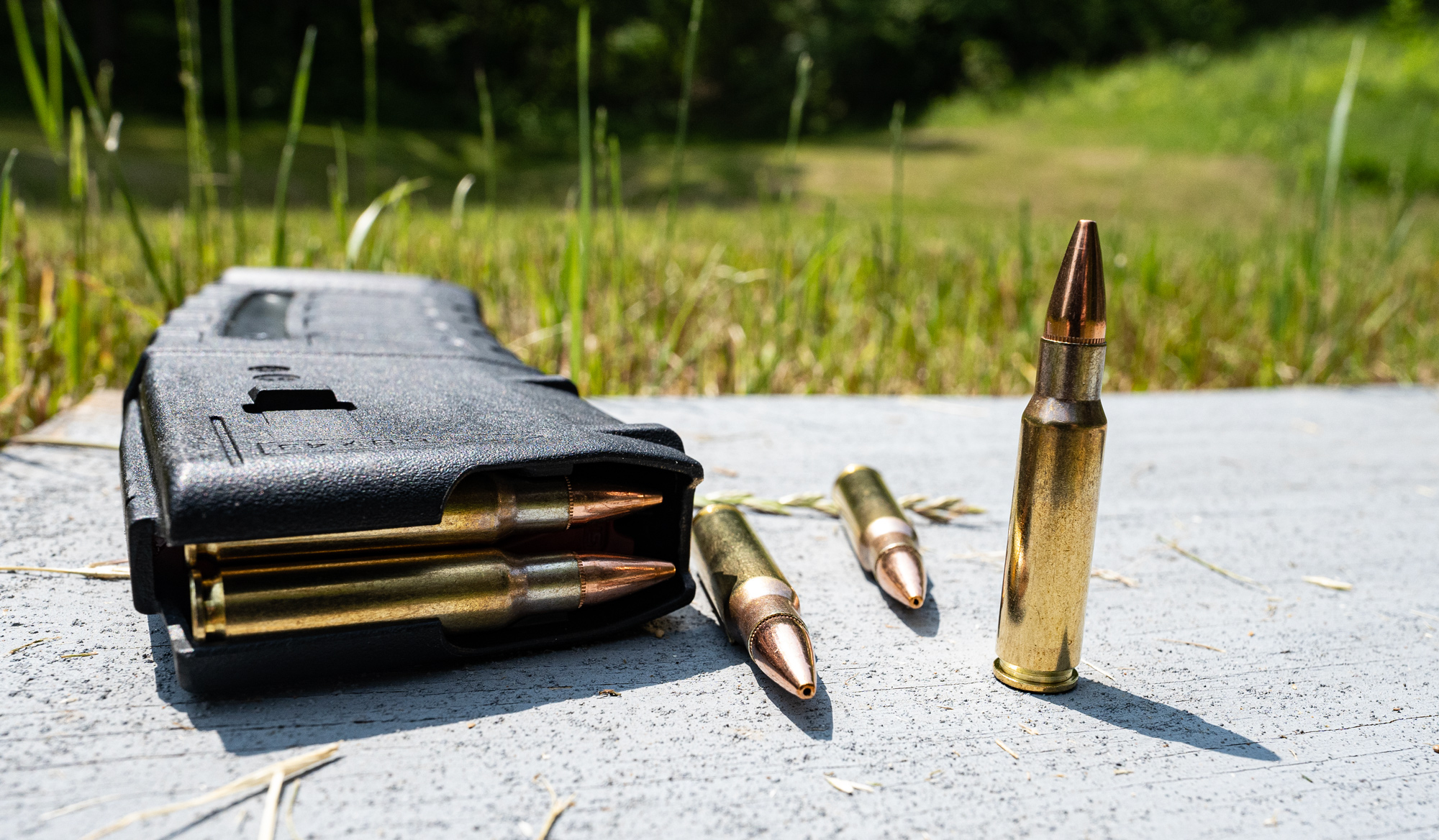 6.8 SPC ammo with a magazine on a shooting bench