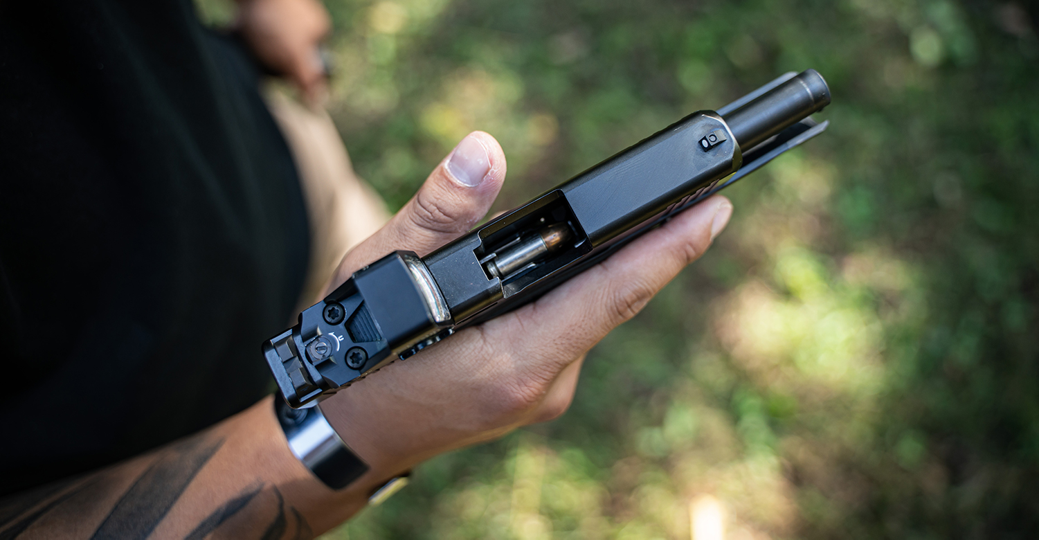 handgun ammunition feeding into a pistol chamber