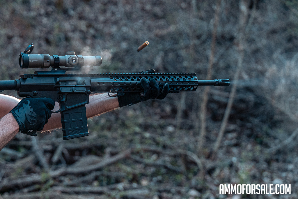 The author shooting a .308 rifle at a shooting range