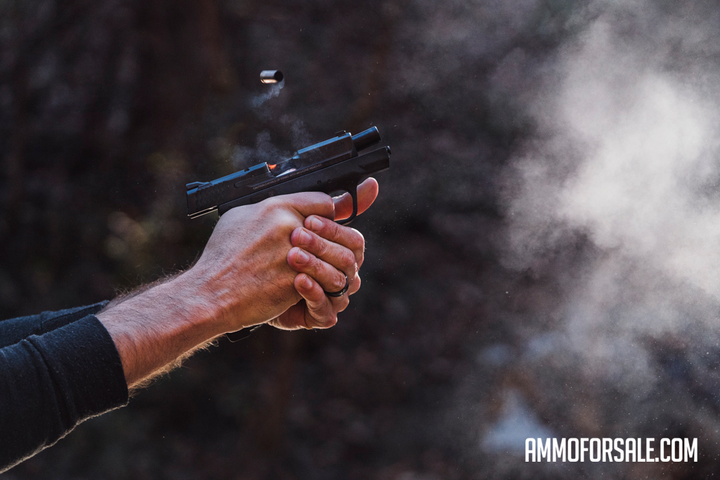 Shooting 9mm ammo out of a short-barreled pistol at the shooting range
