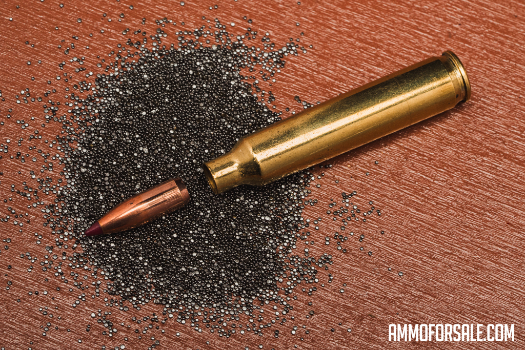 A dissected 204 Ruger rifle cartridge with the bullet pulled from the casing and gunpowder spilled out