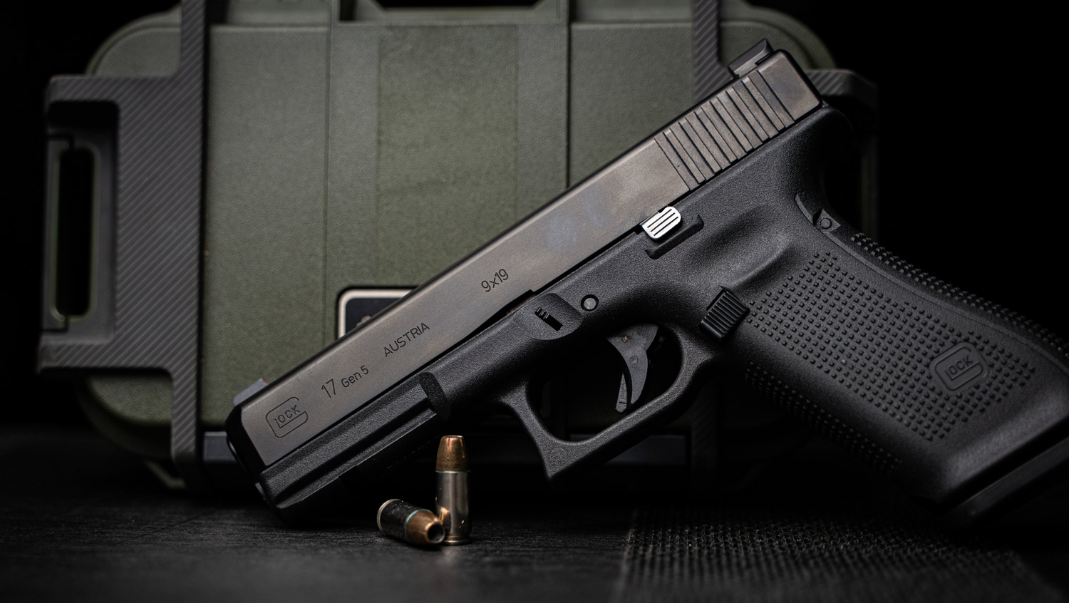 A 9mm Glock 17 displayed in front of an ammo can