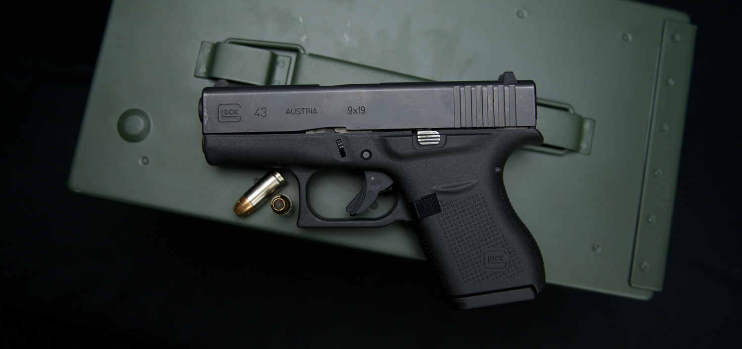 A Glock 43 with 9mm ammunition displayed