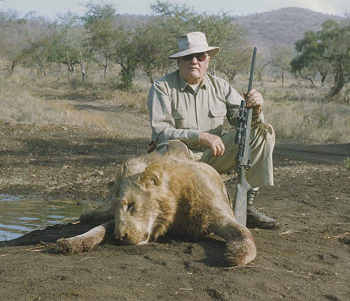 jeff cooper after a hunting trip posing with a lion