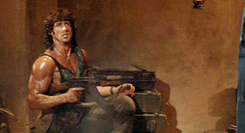 Rambo carrying an AKM rifle