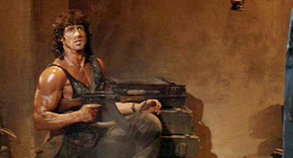 Rambo carrying an AKM rifle