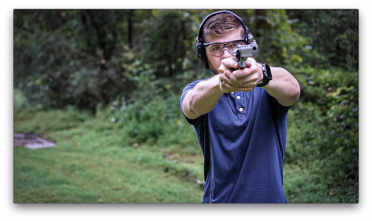 Author shooting the Taurus 627 Tracker at the range as part of his review.