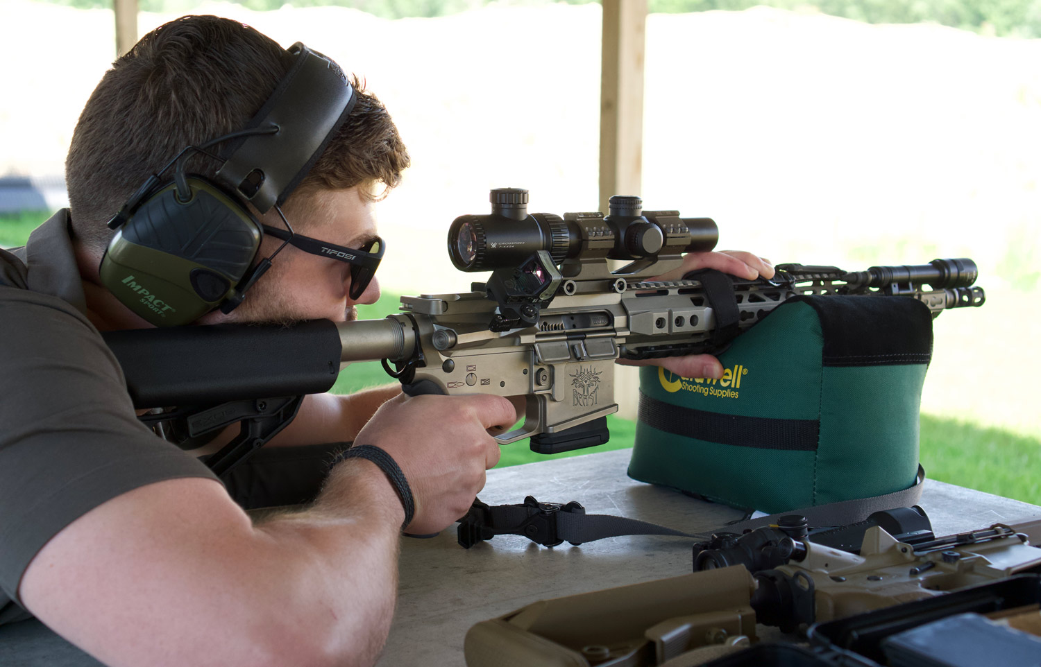 Shooter at a shooting range firing a rifle
