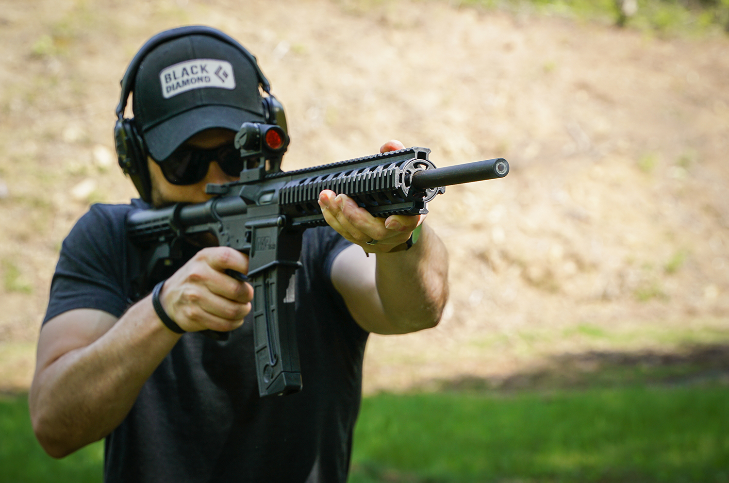 The author firing 22lr ammo through an AR-style rifle at a shooting range