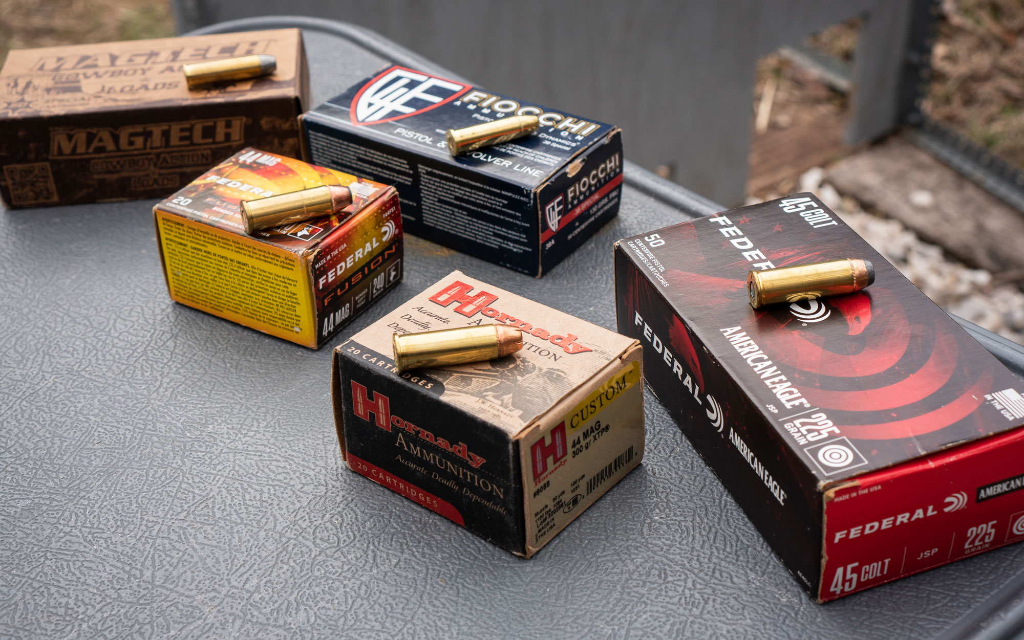 Various revolver calibers displayed on a shooting bench.