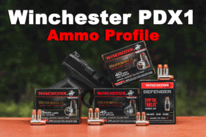 Winchester PDX1 ammo displayed at a shooting range with a pistol